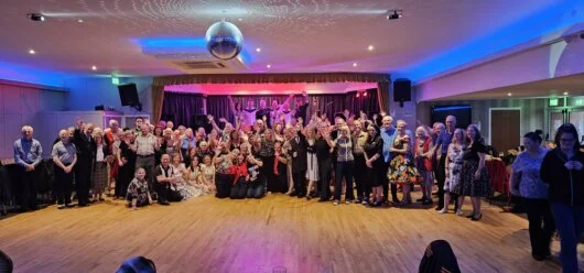 Dance floor and stage with colourful lighting at Poplar Social Club